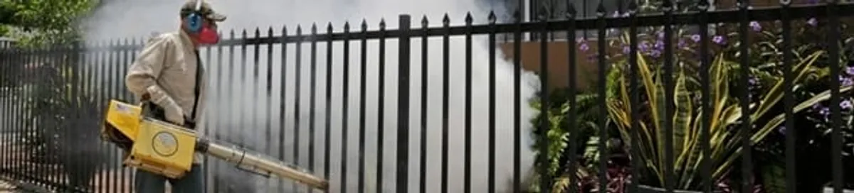 Mosquito control technician fogging a yard perimeter for mosquito reduction in Denver, CO